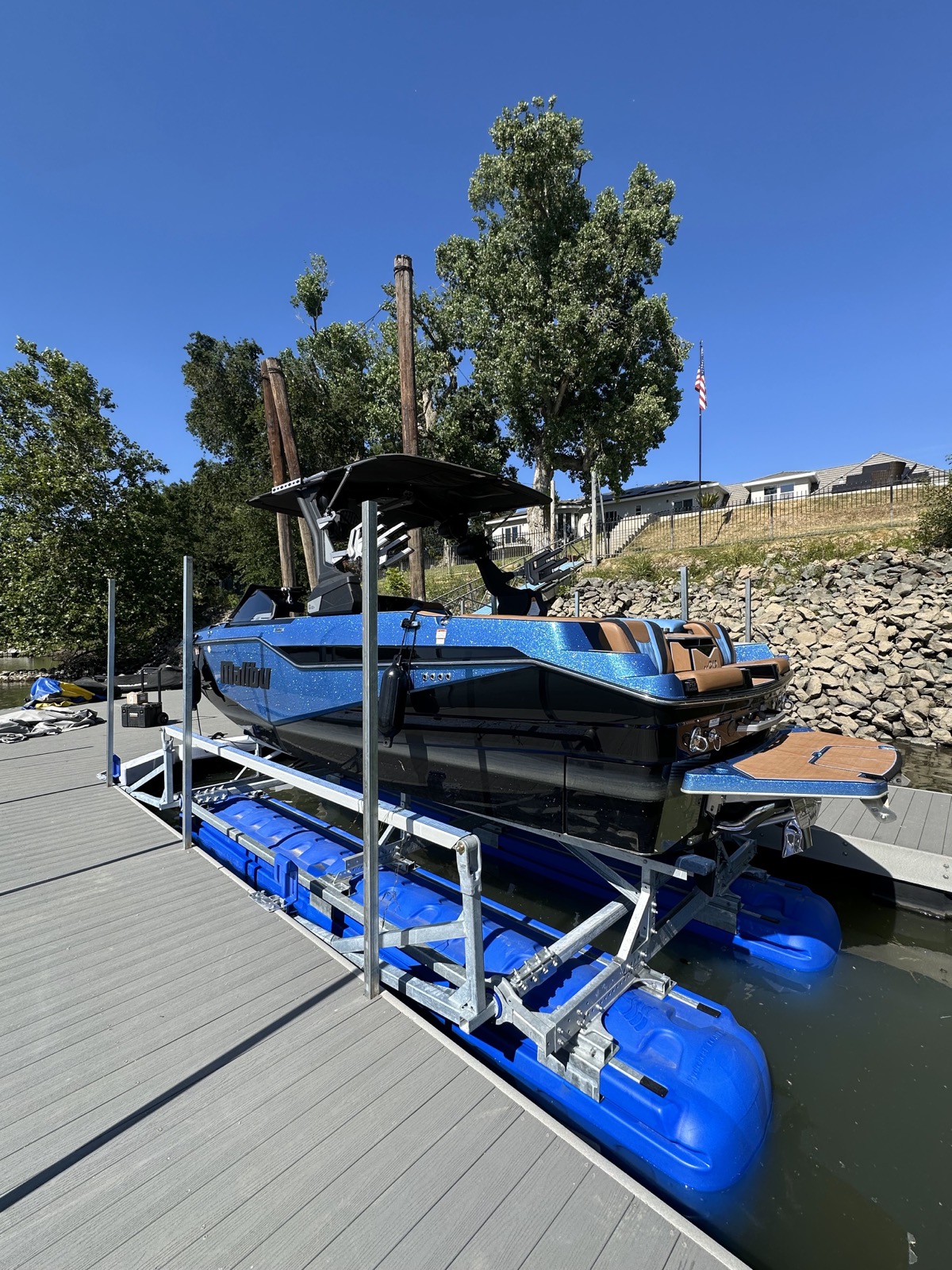 HydroHoist boat lift installed beside a waterfront dock and shoreline